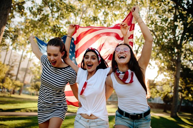 Young and enthusiastic American girls enjoying 4th of july holiday at park