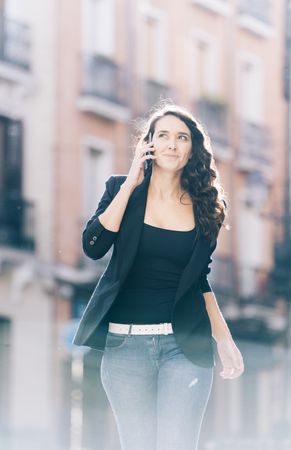 Young female walking with smartphone