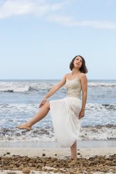 Charming young woman on shore near water
