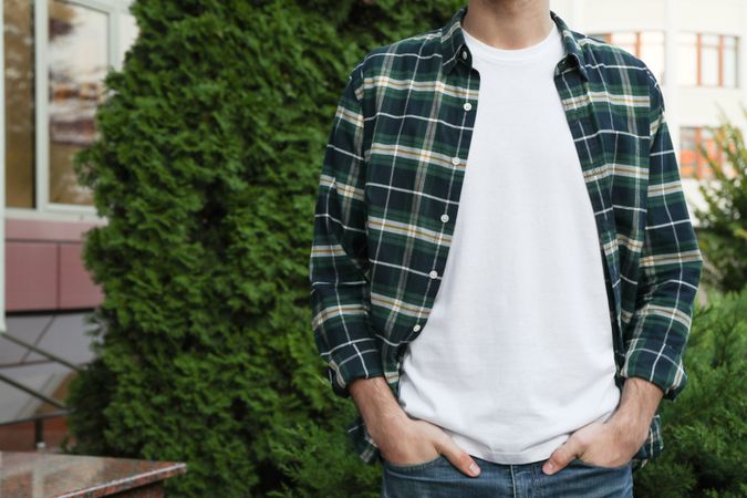 Men in blank t-shirt and green checkered shirt, space for text