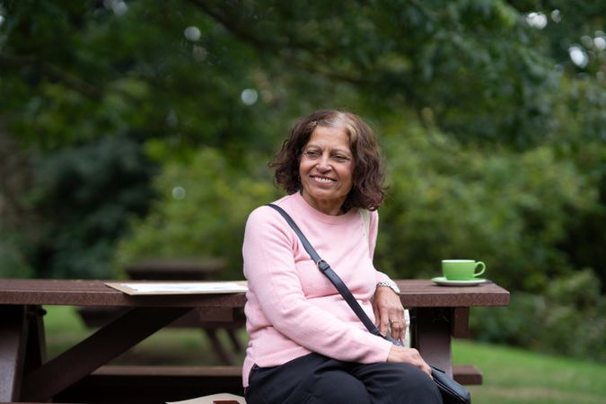 Woman sitting outside with cup of tea
