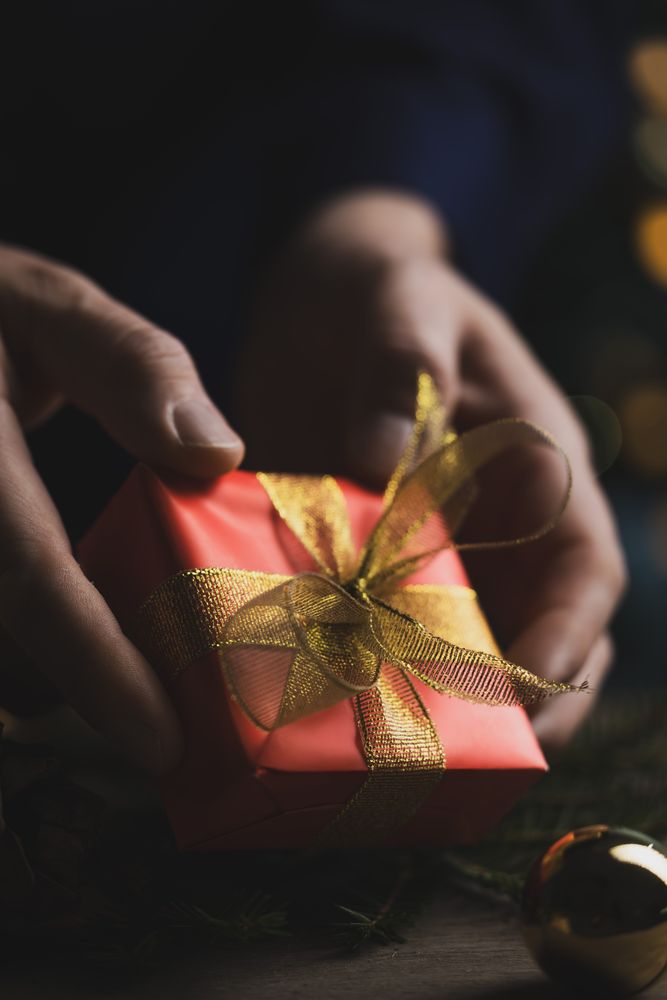 Man holding Christmas gift in hands