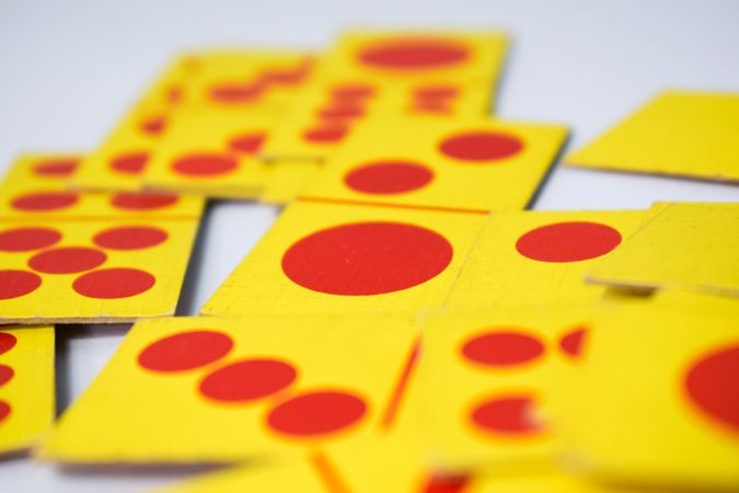 Close up of red and yellow domino playing cards with selective focus