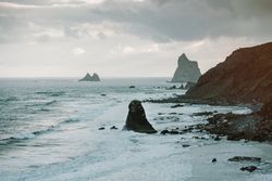 Lonely cliff in sea on cloudy day