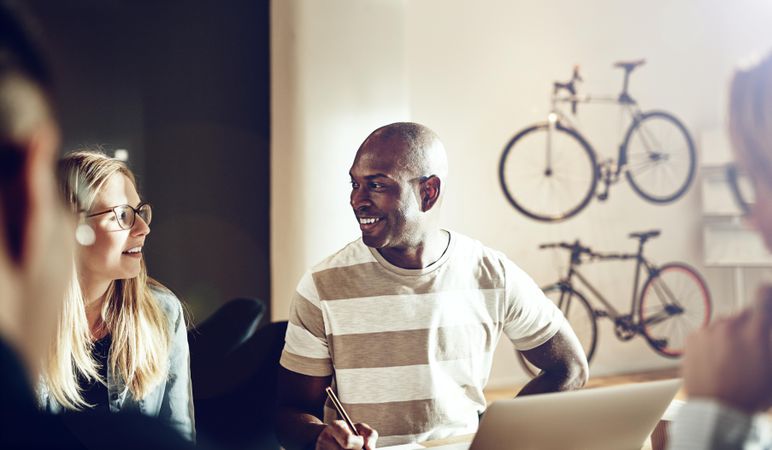 Multi-ethnic group of people working in office with bikes