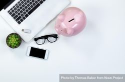 Desktop with piggy bank for investment concept 56wwl4