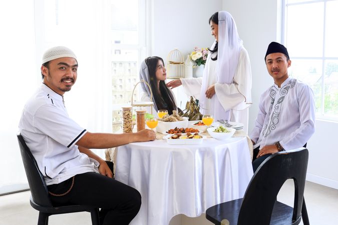 Women and Man Sitting to Celebrate Eid al Fitr