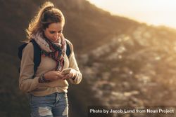Young woman on hiking trip using smart phone 5wgPW5