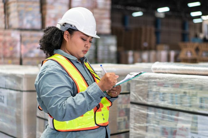 Woman in safety gear working for logistic business