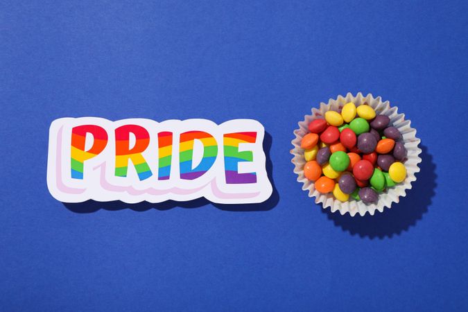 Pride parade concept, festive colorful symbols on blue background.