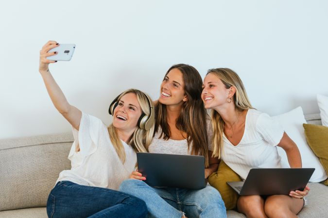 Woman taking a selfie with her sisters