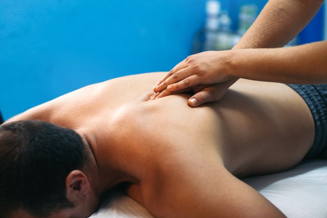 Young woman treating a male patient.