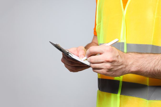 Young man civil engineer with clipboard and pen