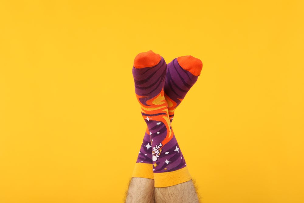 Casual clothes and wearing concept - socks, clothes for foot