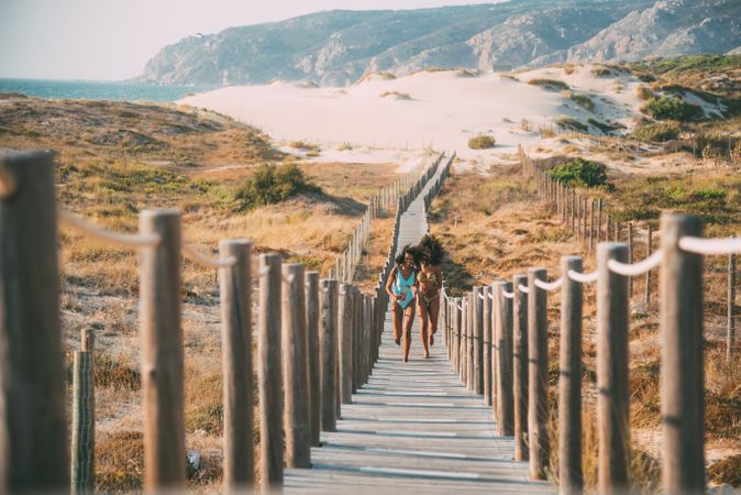 Carefree women running on pier