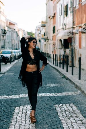 Joyful trendy female in old town street