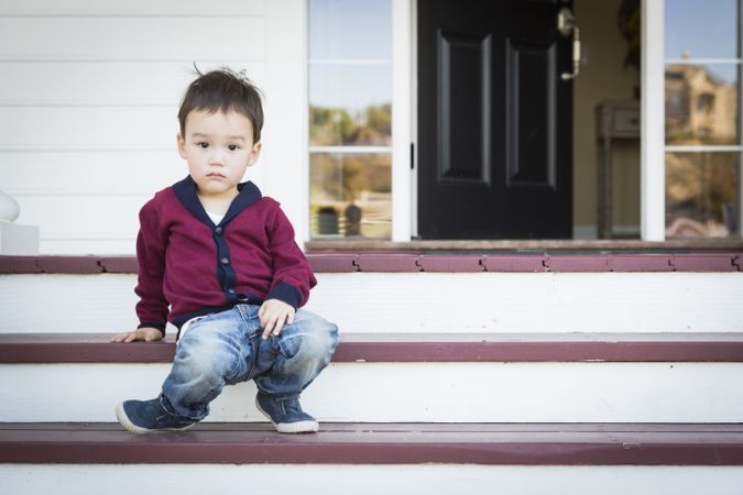 Little Boy Sitting on Front Porch Steps