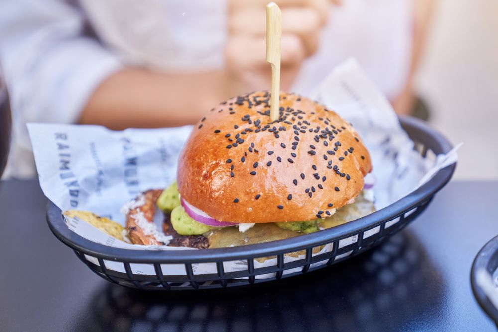 Delicious burger in basket on table