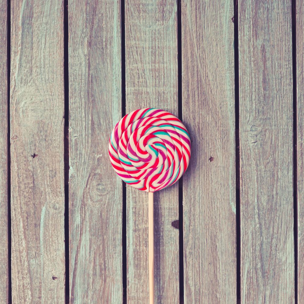 Large swirling lollipop on wood background
