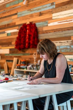 A fashion desinger working on new designs. Vertical shot