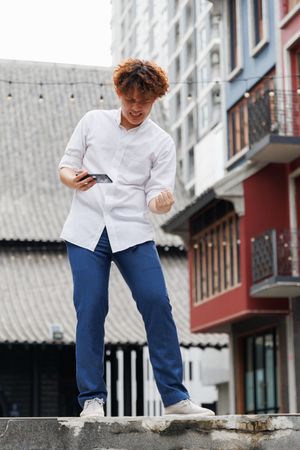 Asian man holding mobile phone