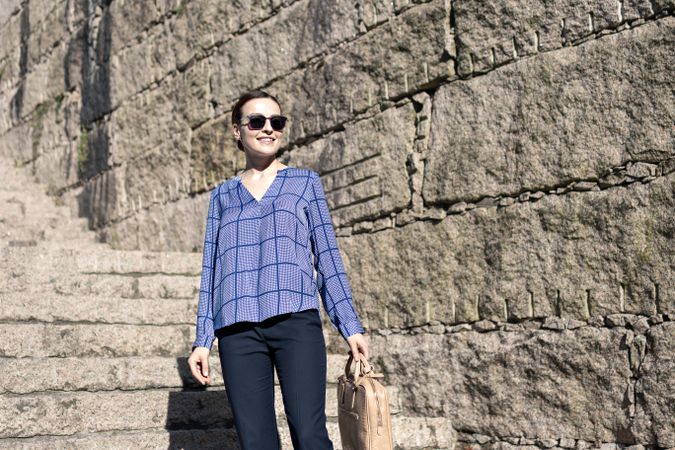 Businesswoman climbing up street stairs
