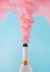 Pastel pink champagne explosion on blue background