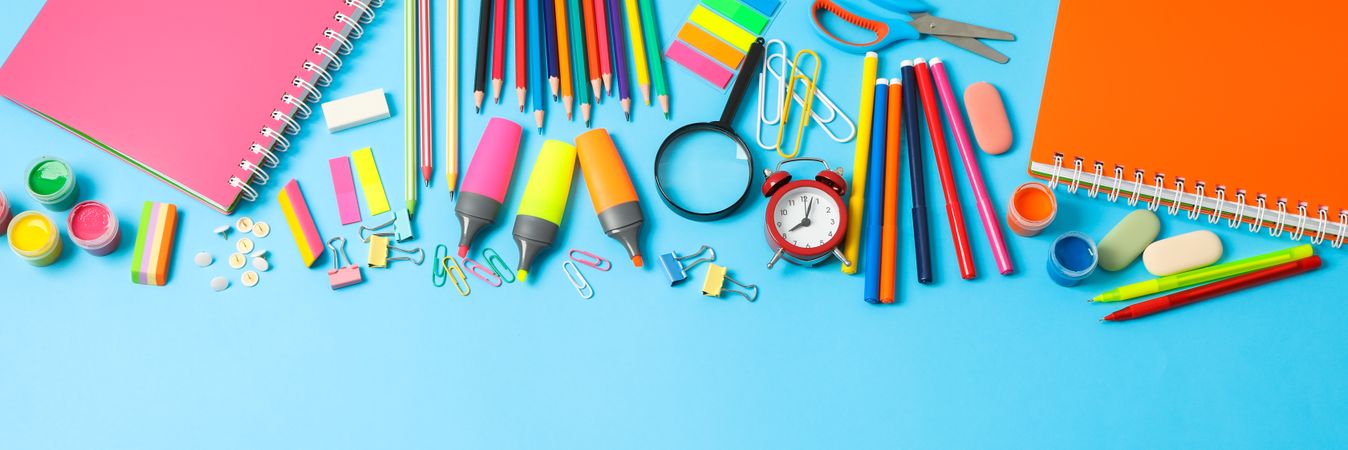 Flat lay composition with school supplies on color background, space for text