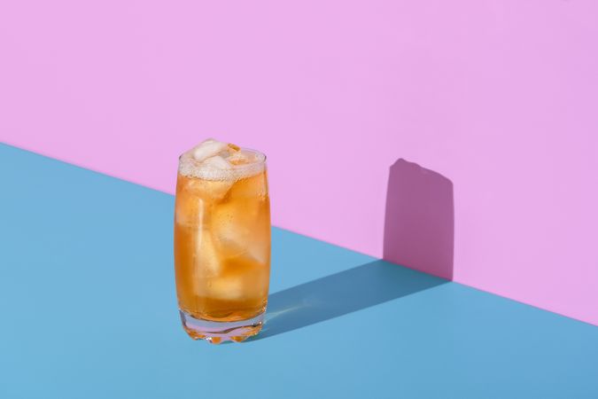 Ice tea glass isolated on a vibrant colored background