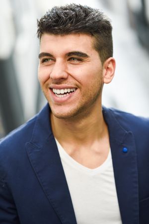 Portrait of handsome smiling man in navy jacket