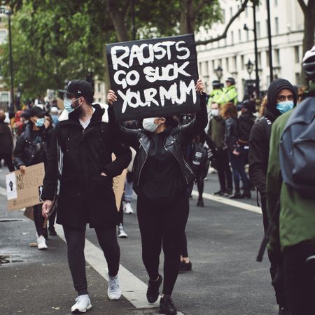London, England, United Kingdom - June 6th, 2020: Woman holds suggestive sign at BLM protest