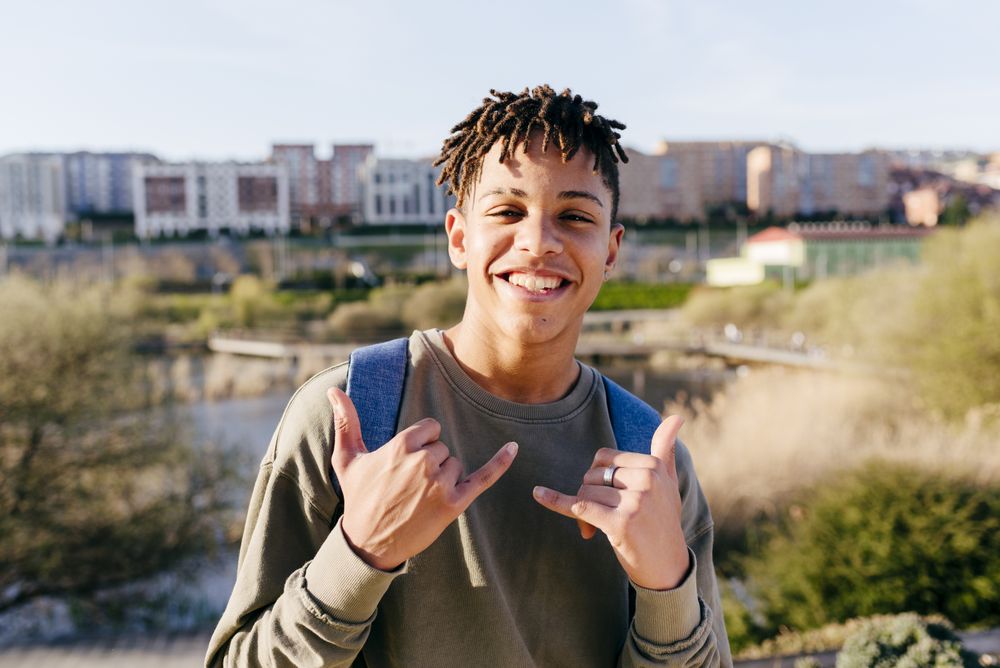 Young Black man showing shaka hand sign