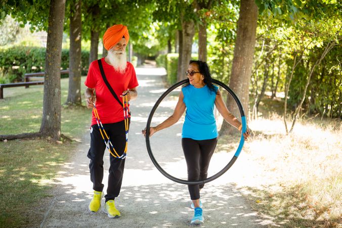 Mature Sikh couple walking through park