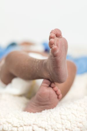Newborn baby feet on soft blanket