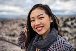 Cheerful woman visiting ancient city