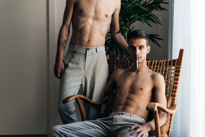 Man sitting in chair with partner behind him