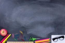 Student supplies on chalkboard for back to school year
