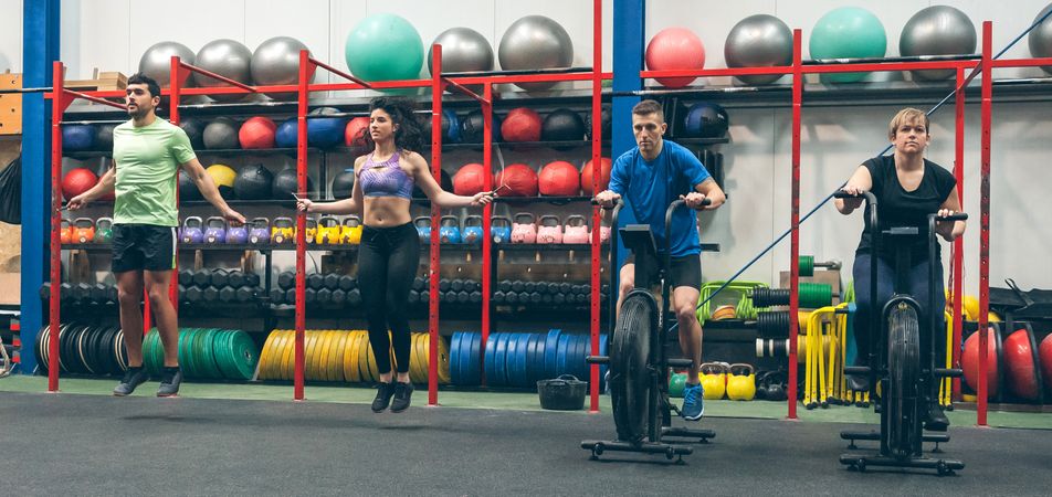 Athletes doing air bike and skipping rope