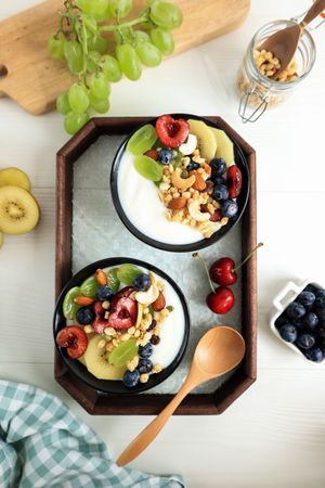 Breakfast with Greek Yogurt, Muesli, and Fruits  on Wooden Background.