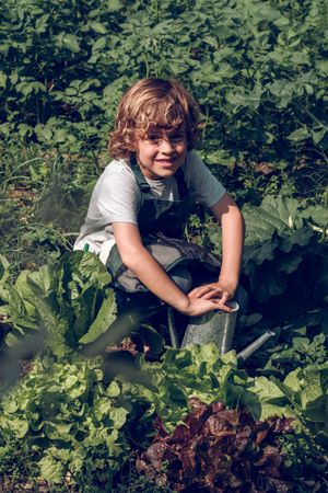 Smiling boy working in garden