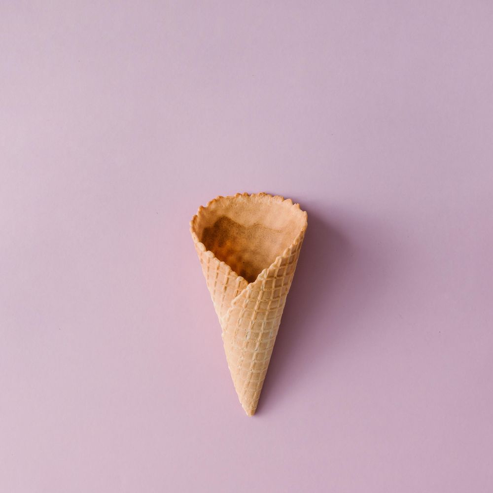 Waffle cone on pastel purple background
