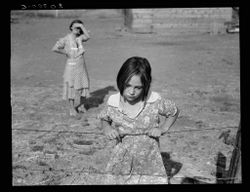 Young girl stands in field in Wapato, Yakima Valley, WA, August 1939 bxPxMb