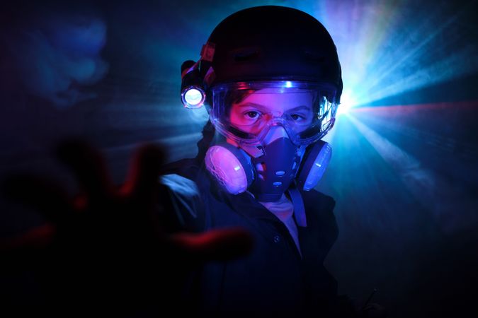 Kid in respirator committing crime in darkness