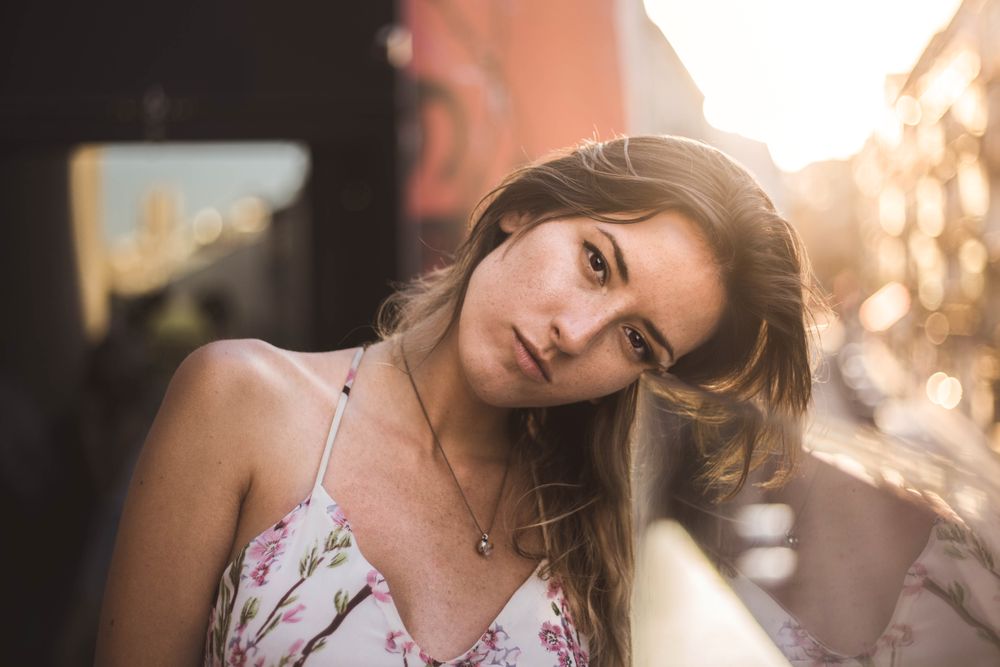 dreamy woman against sunny blurred background