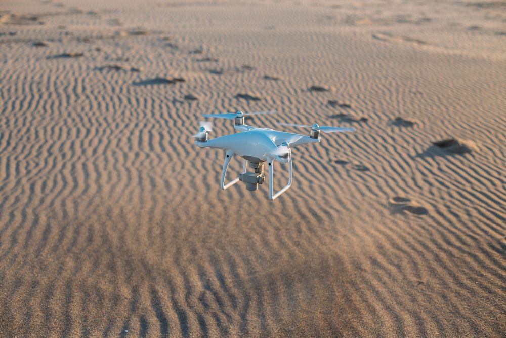 Drone flying over sand