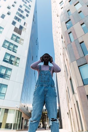 Black man enjoying music in city