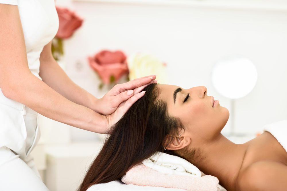 Female receiving relaxing treatment in spa wellness center