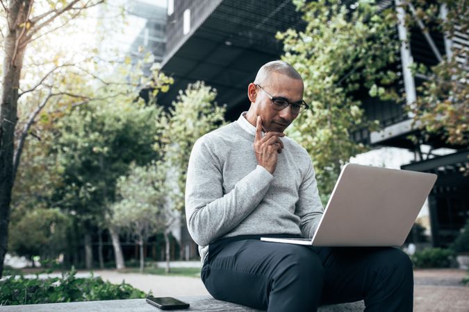 Entrepreneur concentrating on work sitting outdoors
