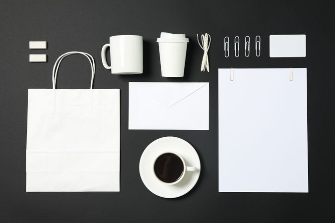 Flat lay composition with blank stationery on dark background, copy space