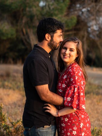 Young happy couple embracing in beautiful garden